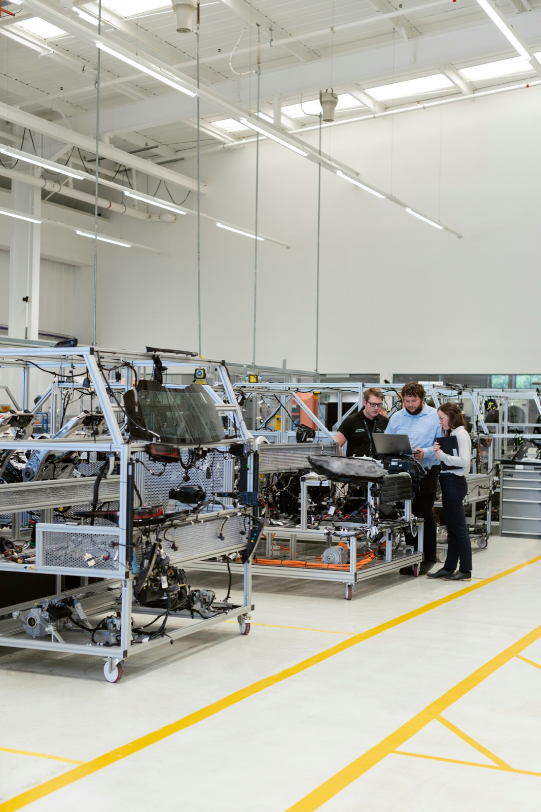 Engineers working in automotive factory for Incure CDM™ UV conveyor automotive electronics bonding