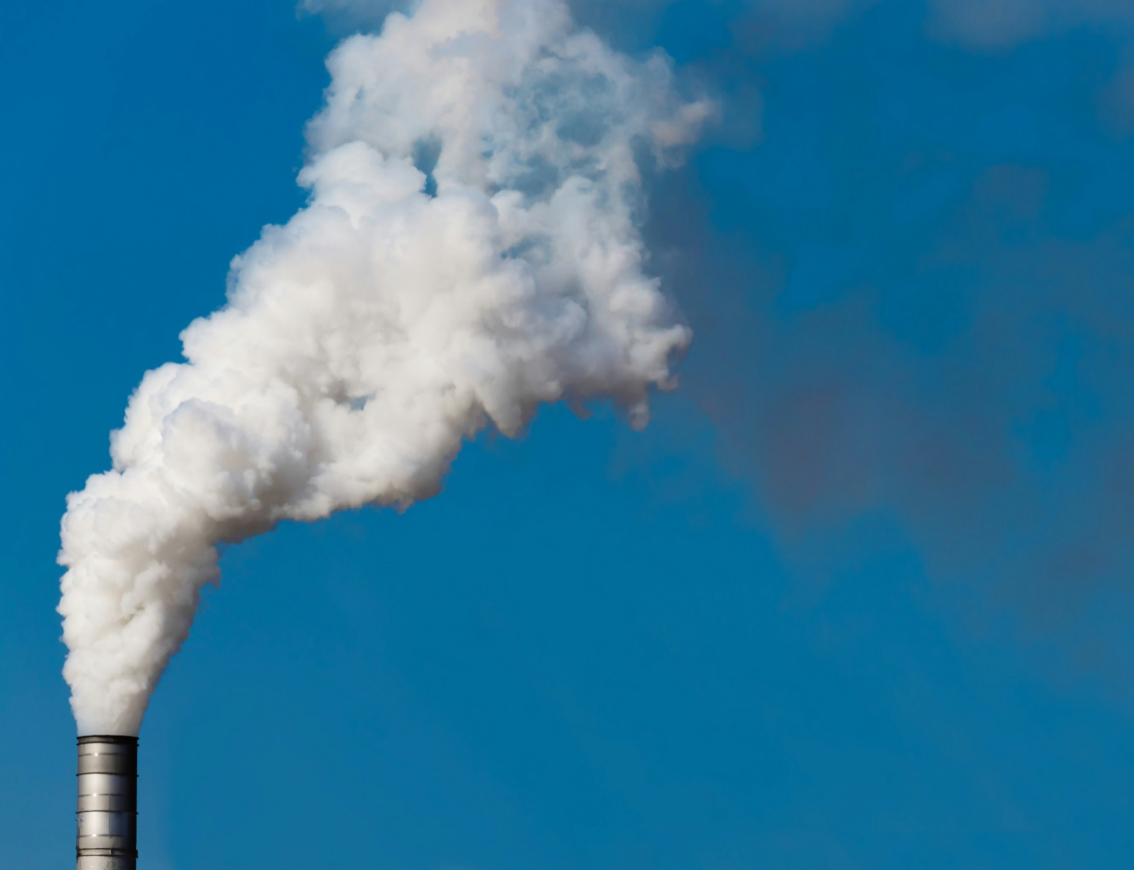 White smoke rising from factory chimney for Epo-Weld™ high emissive ceramic coating process vessel and stack