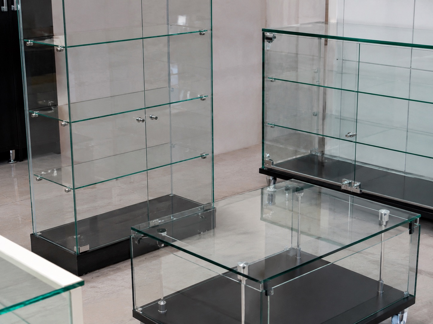 Glass display cases with metal fittings bonded using Uni-Weld™ UV adhesive for furniture and retail display assembly