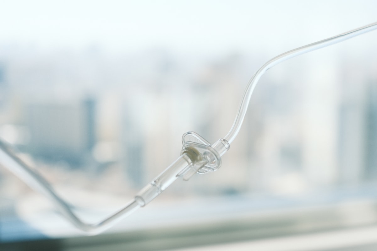 Medical IV drip line tubing with blurred clinical background for Cyro-Weld™ UV medical adhesive catheter and tube set